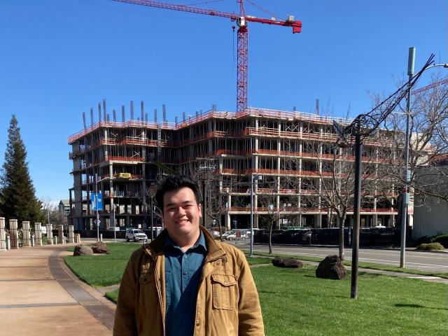 Photo of Bryce Madden at the Aggie Square construction site, courtesy of Bryce Madden