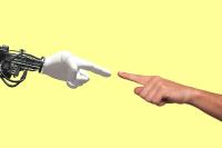 one artificial hand and one human hand touching